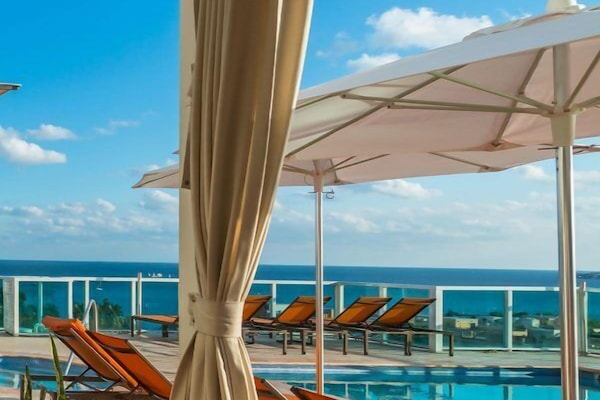 Outdoor pool, open 10:00 AM to 6:00 PM, pool umbrellas, sun loungers