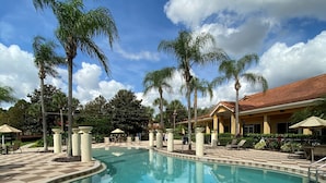 A swimming pool with a tiled deck, palm trees, and a building with a tiled roof. - The Encantada Escape – 3BR Townhome w/ Private Pool (Four Corners)