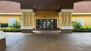 A Club House entrance with a tiled floor, columns, and a yellow facade. - The Encantada Escape – 3BR Townhome w/ Private Pool (Four Corners)