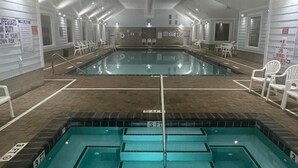 Une grande piscine intérieure dotée de plusieurs couloirs de nage, d’un poste de surveillance pour les sauveteurs et d’un espace bien-être.