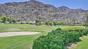 A golf course with a mountainous backdrop, well-maintained grass, and a row of houses. - 259250 3 BR La Quinta Mtn Resort Golf Course Home (La Quinta)