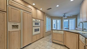 A kitchen with wooden cabinets, a built-in oven, a dishwasher, and a window with blinds. - 259250 3 BR La Quinta Mtn Resort Golf Course Home (La Quinta)