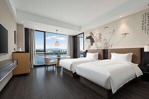 A modern hotel room with two beds, a desk, a chair, and a large window offering a city view. - Yiho Hotel (Fuzhou South Railway Station)  (Fuzhou)
