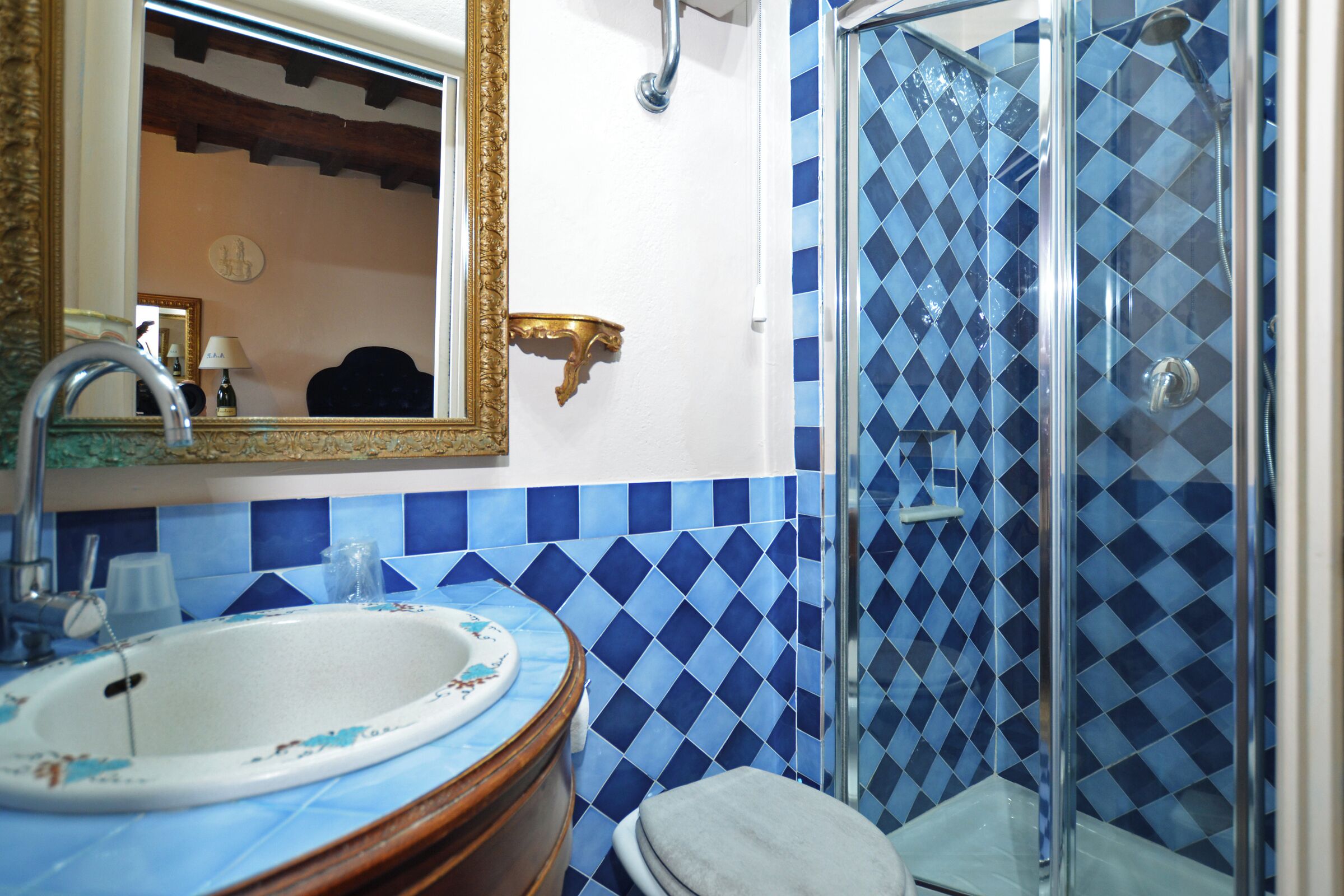 Une salle de bain avec un lavabo, un miroir et une douche.