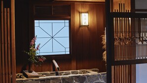 A traditional Japanese room with tatami flooring, a shoji screen, and a wooden sliding door. - Sagiya Sensorai (Kaminoyama)