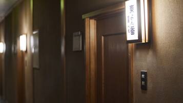 A hallway with wooden doors and a sign indicating room number 101.