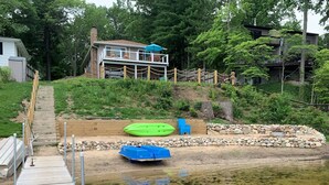 A house with a deck and a small dock.