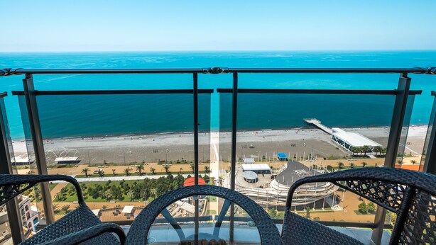 A balcony with a view of the beach and ocean. - Orbi Sea Towers Hotel Official (Batumi)