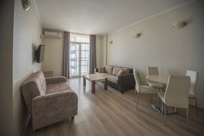 Standard Apartment | Living area | 70-cm flat-screen TV with cable channels, TV - Orbi Plaza Hotel Official (Batumi)