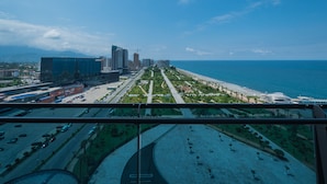 A cityscape with a beachfront, high-rise buildings, and a road leading to the beach. - Orbi Beach Tower Hotel Official (Batumi)