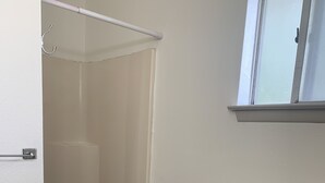 A bathroom with a shower, a toilet, and a window above the toilet. - 1326-#9 Comfy studio in downtown  (San Antonio)
