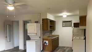 A compact kitchen with a refrigerator, stove, and microwave. - 1326-#9 Comfy studio in downtown  (San Antonio)