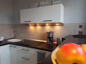 Apartamento standard | Cozinha privada | Geladeira, cooktop, cafeteira/chaleira, chaleira elétrica