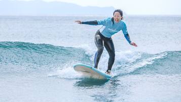 A person surfing on a wave in the ocean.