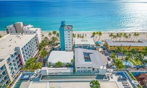 Enjoy beachside views from this hotel's modern buildings, set amidst a tropical ambiance with palm trees and a central pool area.