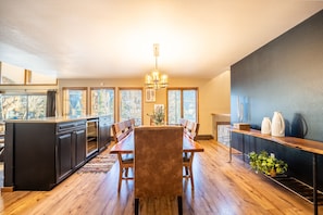 Enjoy meals in the spacious kitchen and dining area with a large dining table and sink.