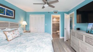 A bedroom with a bed, nightstand, dresser, and a ceiling fan. - Snorkel & Dive Legendary Coral Reefs - Then Relax Poolside with a Drink! (Tavernier)