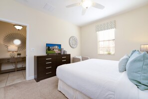 A bedroom with a bed, dresser, desk, and a ceiling fan. - 1450 Rolling Fairway Drive (Davenport)
