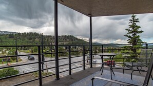 A balcony with a view of a road and mountains. - Gold Creek Condo: Downtown, Amazing Views (Breckenridge)