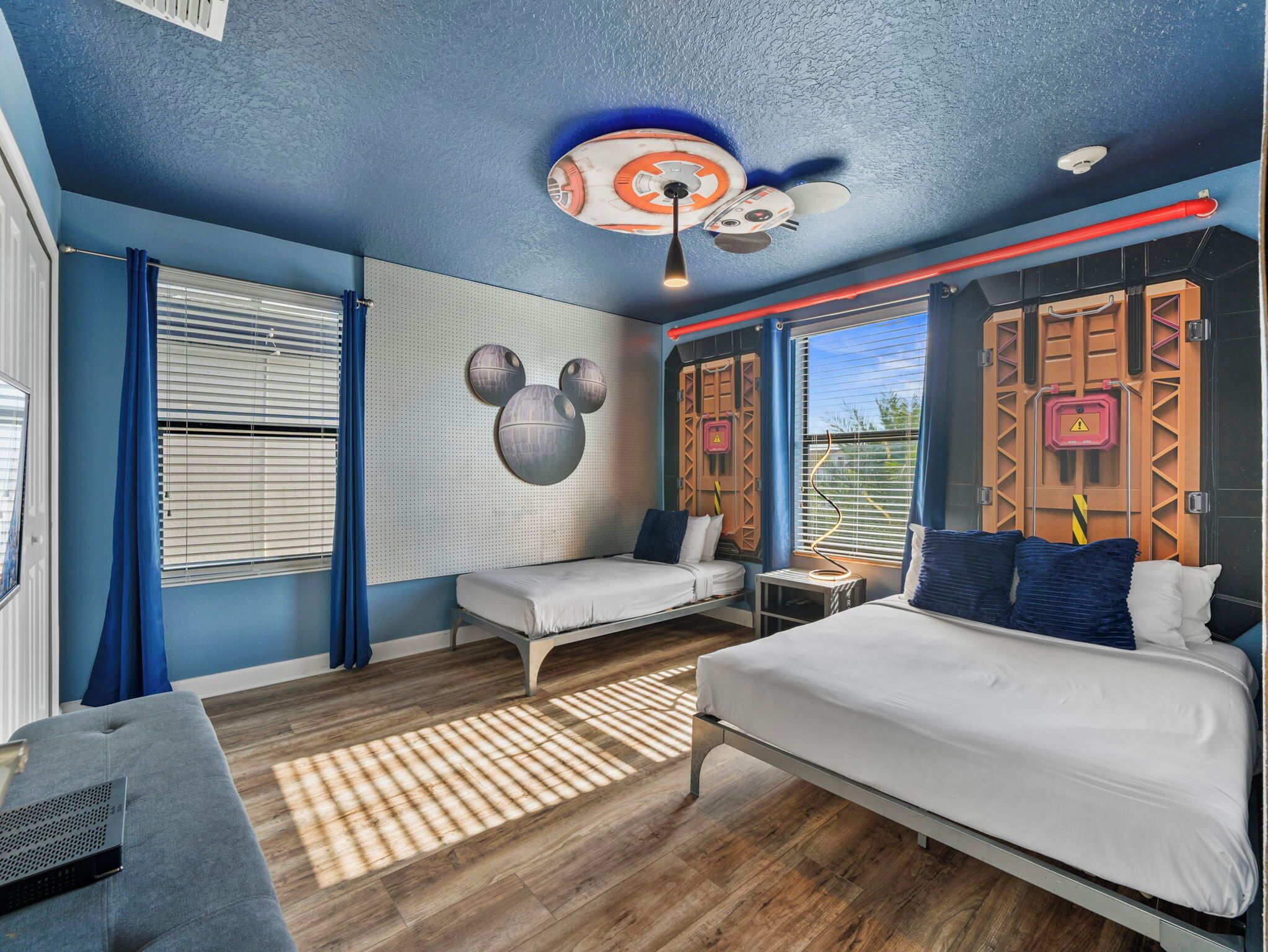 A modern bedroom with a bed, a desk, and a chair.