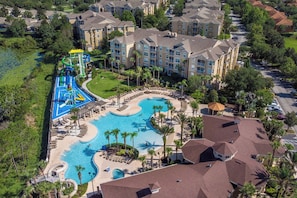 A resort with a large swimming pool, a water park, and multiple hotel buildings.