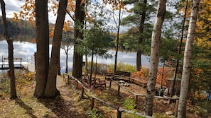 Relax by the serene lake, surrounded by trees and a wooden dock.