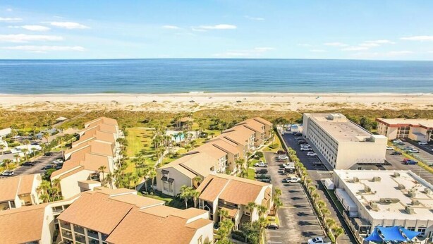 A coastal hotel with multiple buildings, a parking lot, and a beach view. - 2 Bedroom Pet-friendly ocean view condo - OV3 (St Augustine)