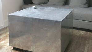 A modern living room with a grey sofa, a metallic coffee table, and a sloped ceiling. - Studio Bastille Lappe CityCosy (Paris)