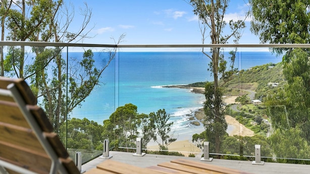 A wooden bench overlooking a coastal view with a clear sky. - Vue Sur La Mer (Wye River)