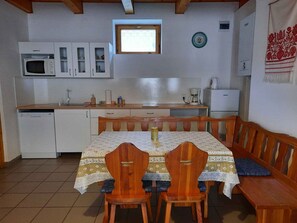 Enjoy casual meals at the kitchen's dining area, which features a table and bench.
