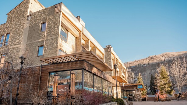 A modern building with a stone facade, large windows, and a wooden entrance. - Vail21 601 - 3 Bedroom Gold (Vail)