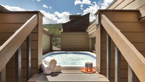 A hot tub with towels and drinks, surrounded by wooden walls and a scenic view. - Vail21 601 - 3 Bedroom Gold (Vail)