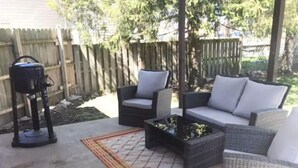 A patio with outdoor furniture, a grill, and a decorative rug. - Fun getaway house with arcade. Cedar Point/Kalahari/Sports Force Park/Summit Rac (Norwalk)
