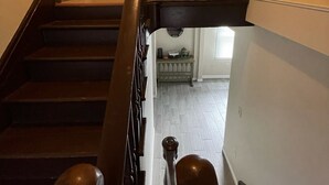 A staircase with a black handrail and a picture of horses on the wall above. - Fun getaway house with arcade. Cedar Point/Kalahari/Sports Force Park/Summit Rac (Norwalk)