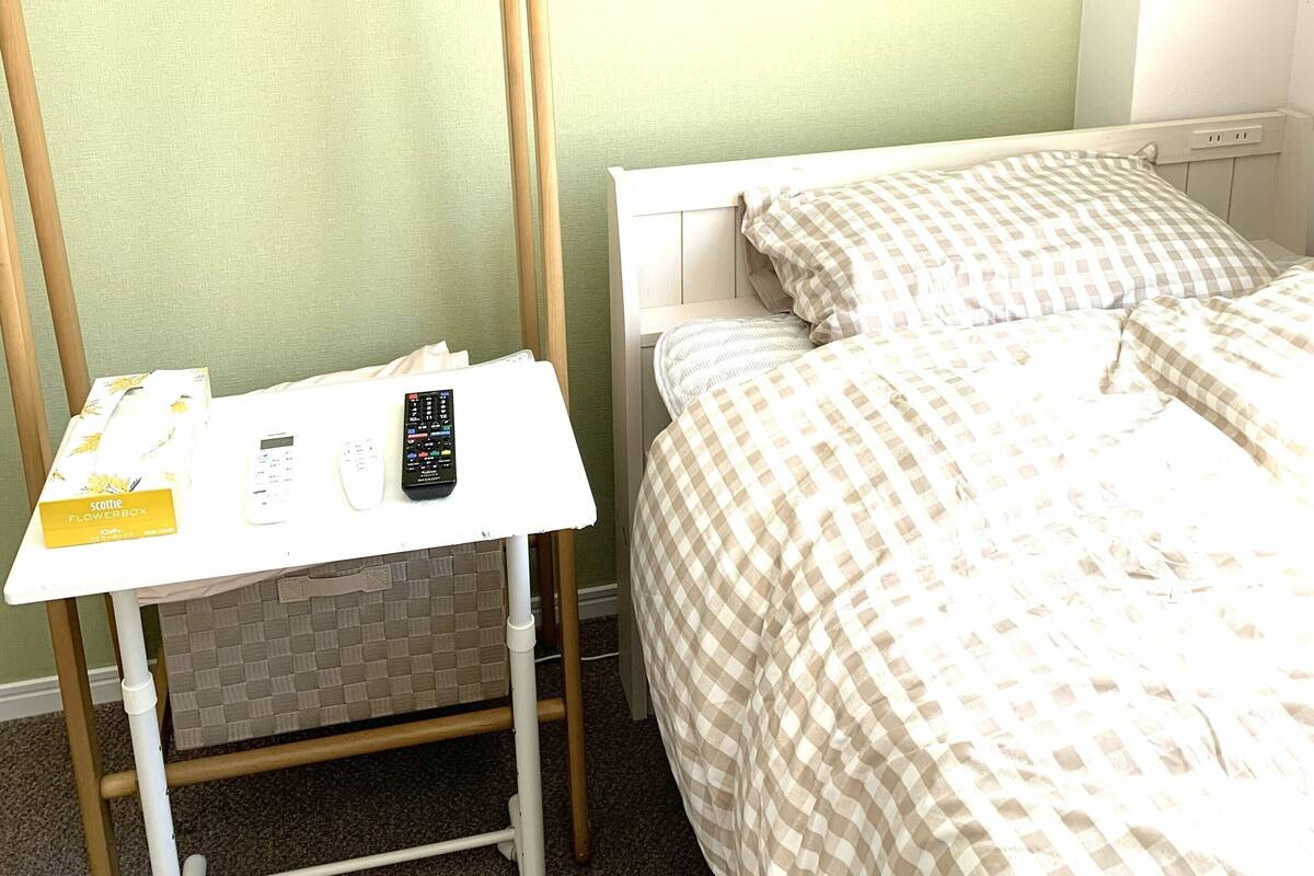 A small room with a bed, a desk, and a chair.