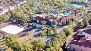 An aerial view of a residential area with houses, a swimming pool, and a landscaped park. - Serenity By Your Private Pool! Excellent Reviews! Resort Living! 4396 (Davenport)