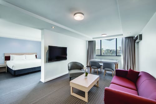 Deluxe Suite - King | Living area | 50-inch LCD TV with cable channels, TV, Netflix