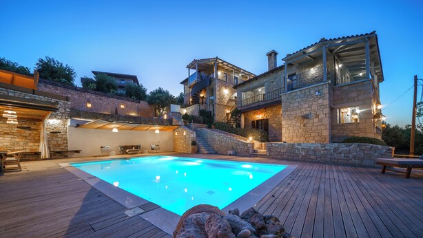 A modern house with a swimming pool, stone walls, and a wooden deck. - Asion Villa Orion with Private Pool (Kato Asites)