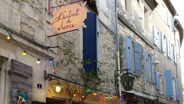 A restaurant named "Bistro de Marie" with outdoor seating and a signboard.