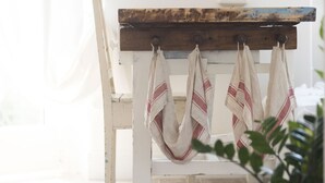 A rustic wooden table with a white chair, a hanging cloth rack, and a potted plant. - ☸THE SEA HOUSE w / t Sea view  (Livorno)