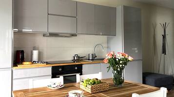 Standard Apartment | Private kitchen | Fridge, stovetop, electric kettle, cookware/dishes/utensils