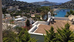 A coastal residential area with a view of the sea, a marina, and a hill in the distance. - Life Butiq Hotel (Bodrum)