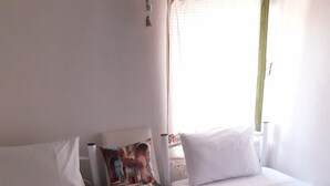 A hotel room with two single beds, a small table, and a window with curtains. - Yesil Konak Ayvalik (Ayvalik)