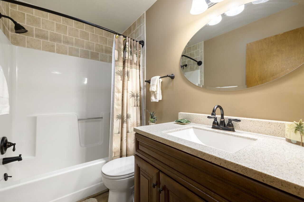 A bathroom with a bathtub, toilet, and sink.