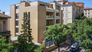 A multi-story building with balconies, a small tower-like structure on the roof, and a tree in the foreground. - T3 large terrace "Sanguinari" (Ajaccio)