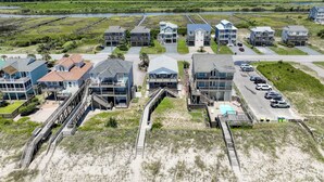 A coastal residential area with beachfront properties, including houses with balconies and a swimming pool. - The Surf  - Surf's Up!  Oceanfront  Getaway!!   (North Topsail)