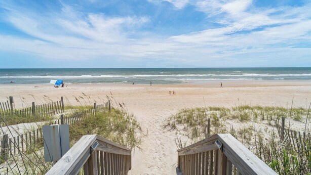 A beach with a wooden boardwalk leading to the shore, sandy beach, and ocean waves. - The Surf  - Surf's Up!  Oceanfront  Getaway!!   (North Topsail)
