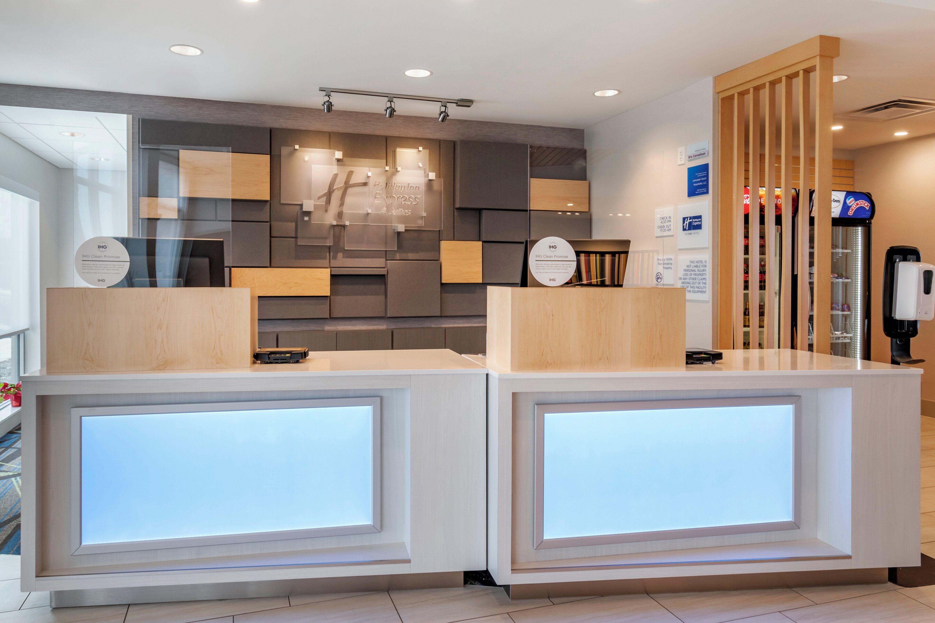 A hotel reception desk with a modern design, featuring a clean and organized layout with a neutral color palette.