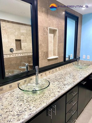 A bathroom with a double sink, large mirror, and a granite countertop. - Linda Vista 105 (2Bedroom-2Bathroom) By FMI Rentals (Puerto Peñasco)