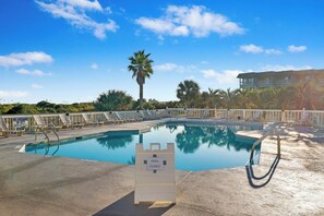 A swimming pool with a closed pool sign, lounge chairs, and a palm tree. - Beachfront well stocked 1 bedroom sea cabin w/ beach view, pier, community pool. (Isle of Palms)